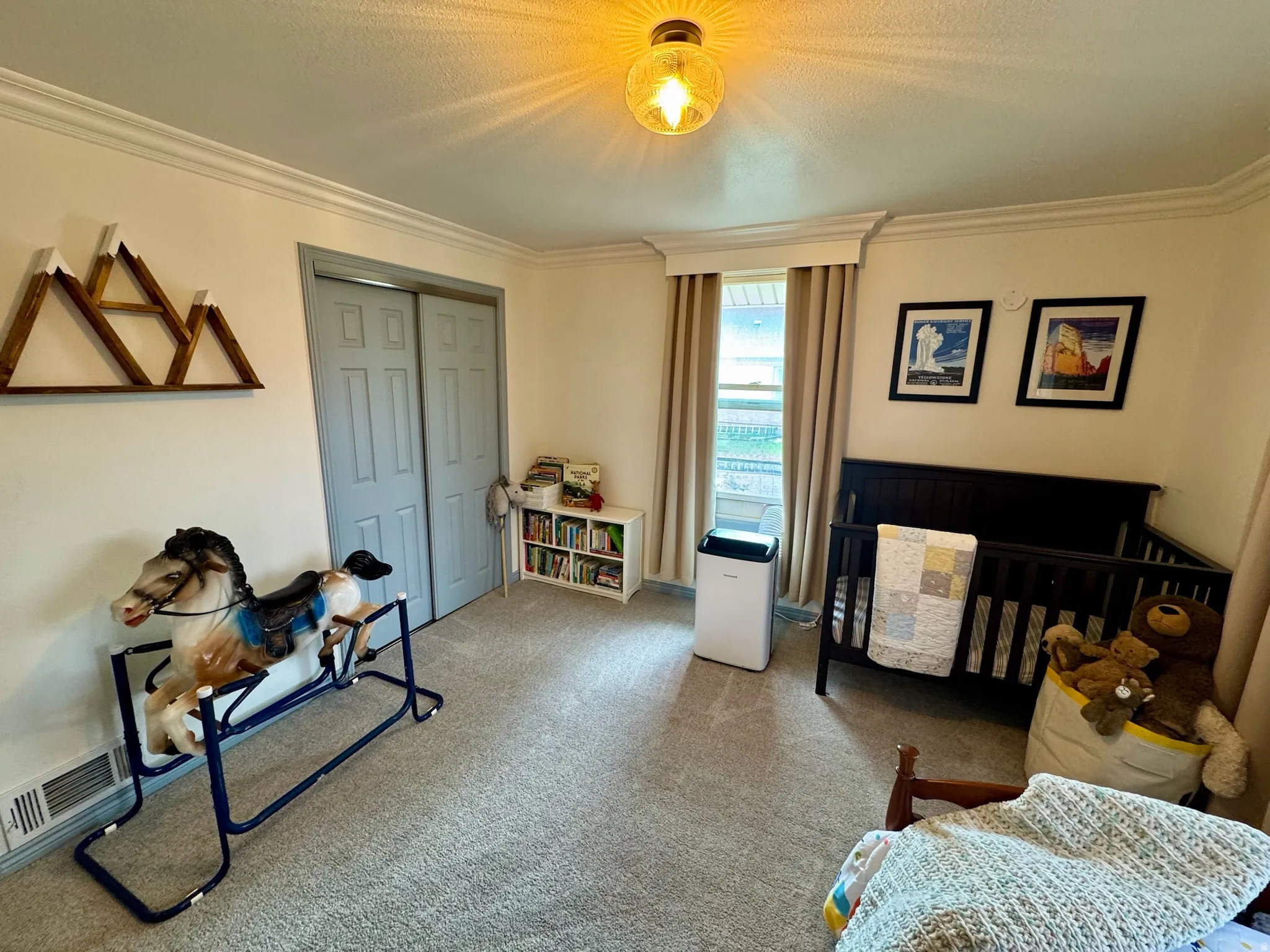 2nd bedroom. Recessed lighting fixture, light-toned wall paint, crown molding, gray carpet flooring, and bi-fold closet doors