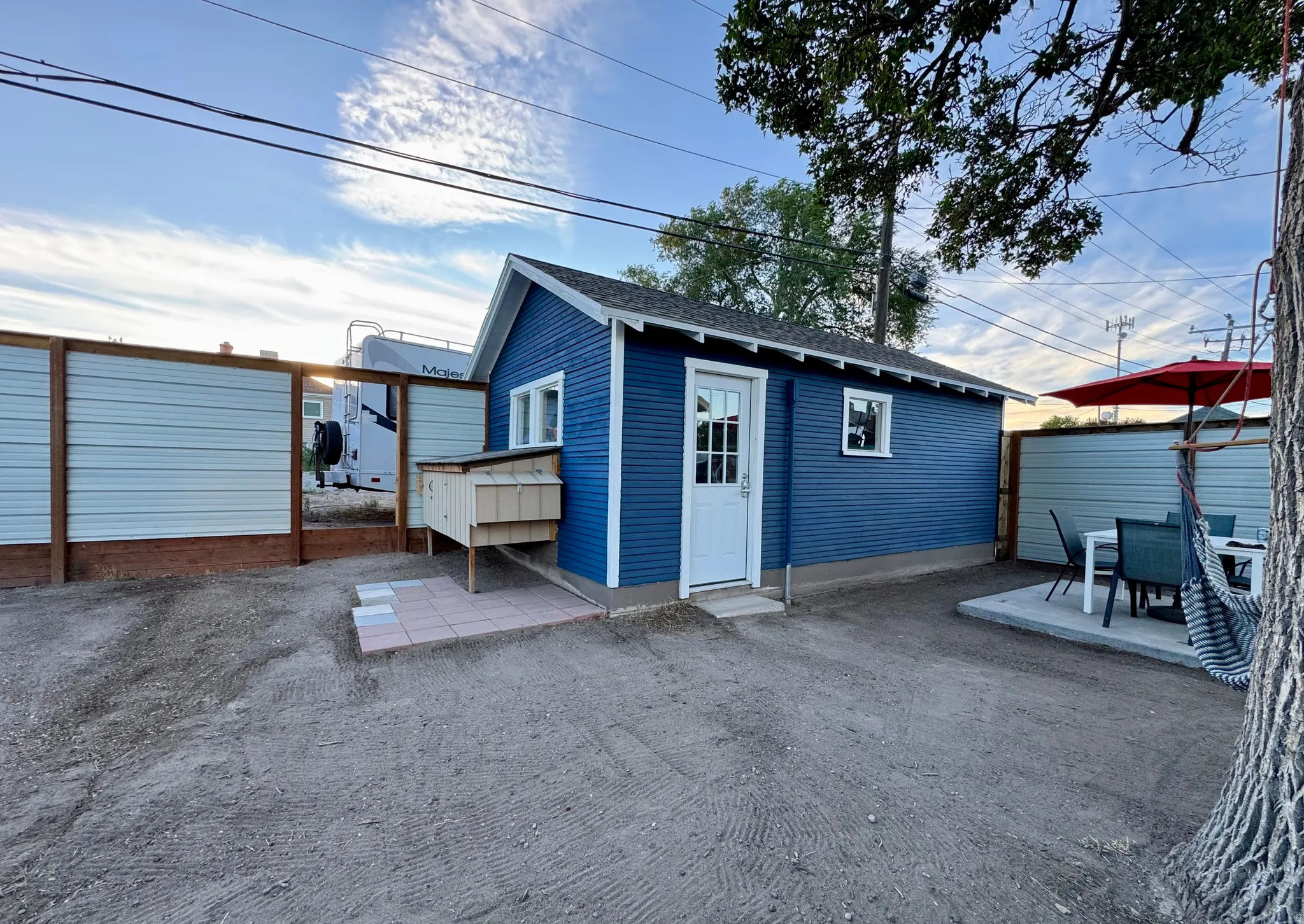 Detached garage/workshop with concrete patio, and fenced perimeter