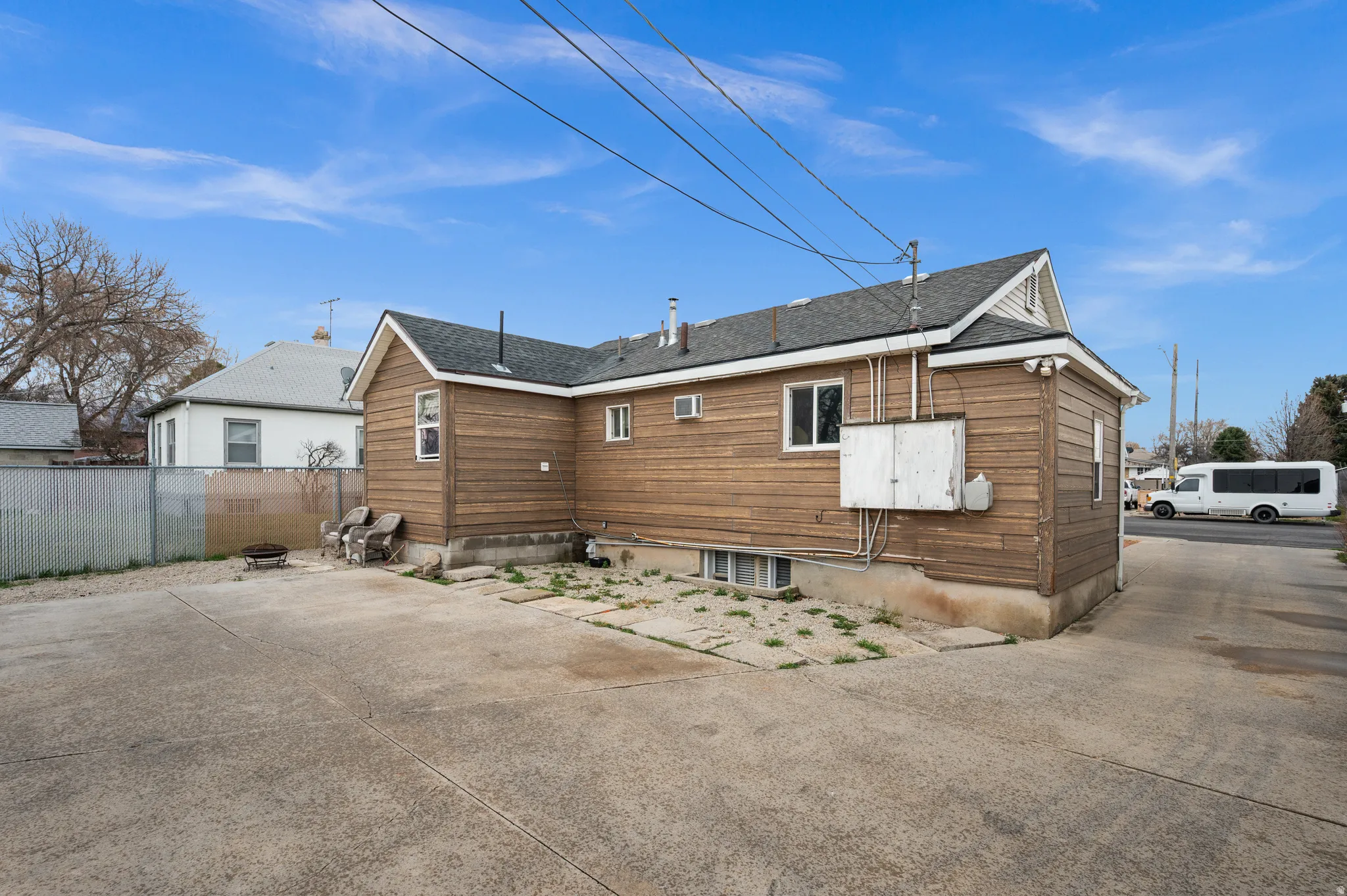 Wood siding exterior with a shingle roof and concrete driveway