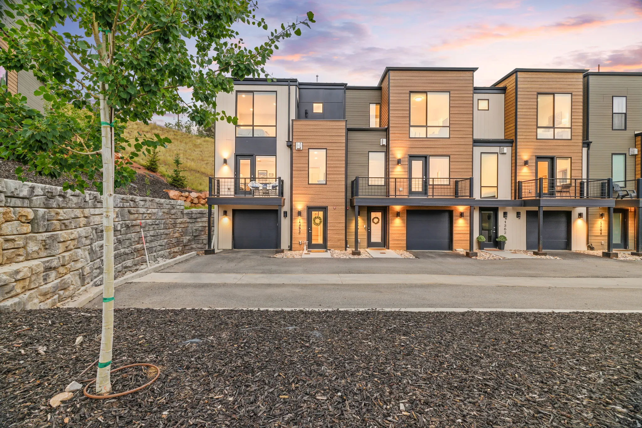 Contemporary townhomes featuring multi-level facades, integrated garages, and private balconies