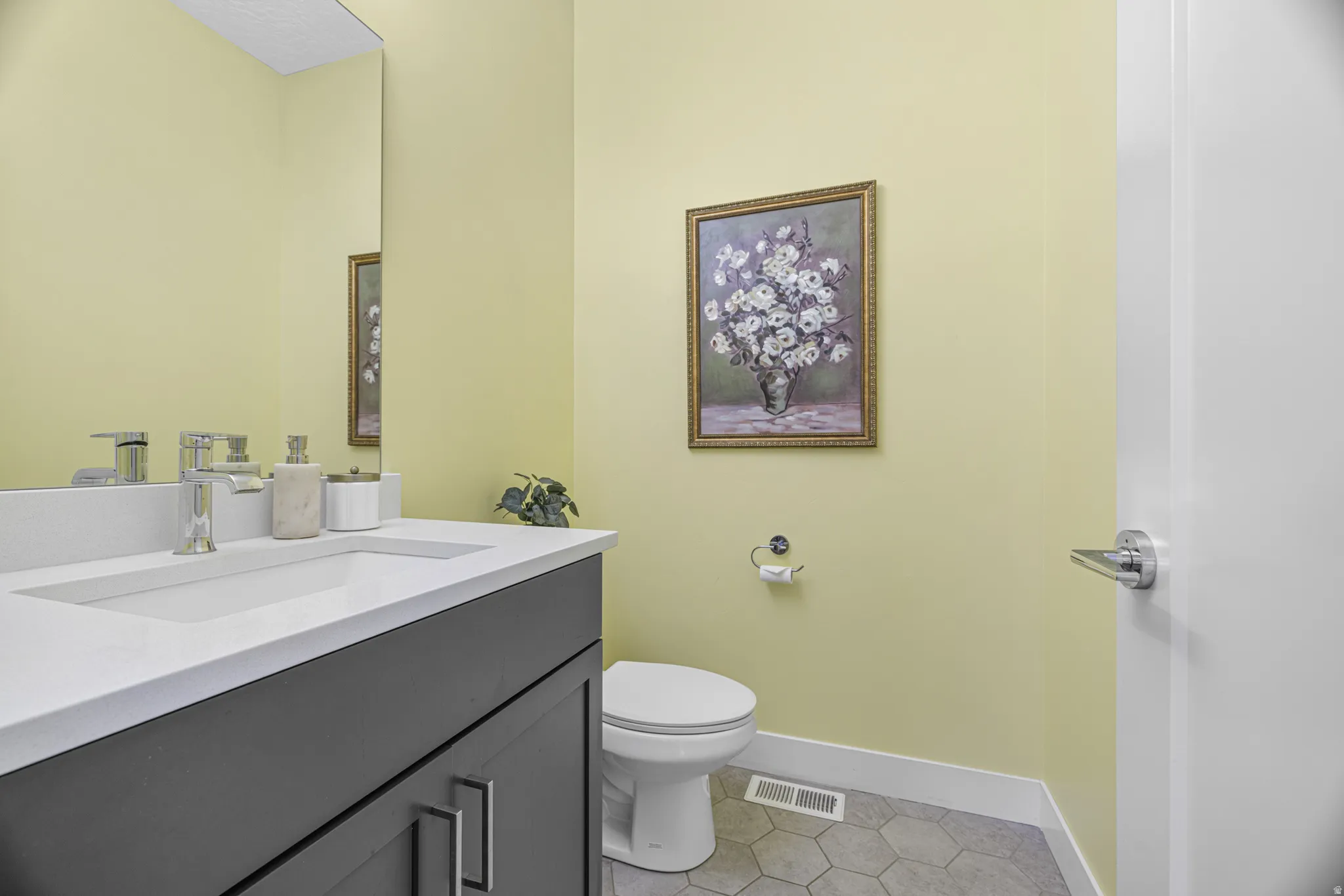 Vanity with an integrated rectangular sink, chrome faucet, and dark cabinetry