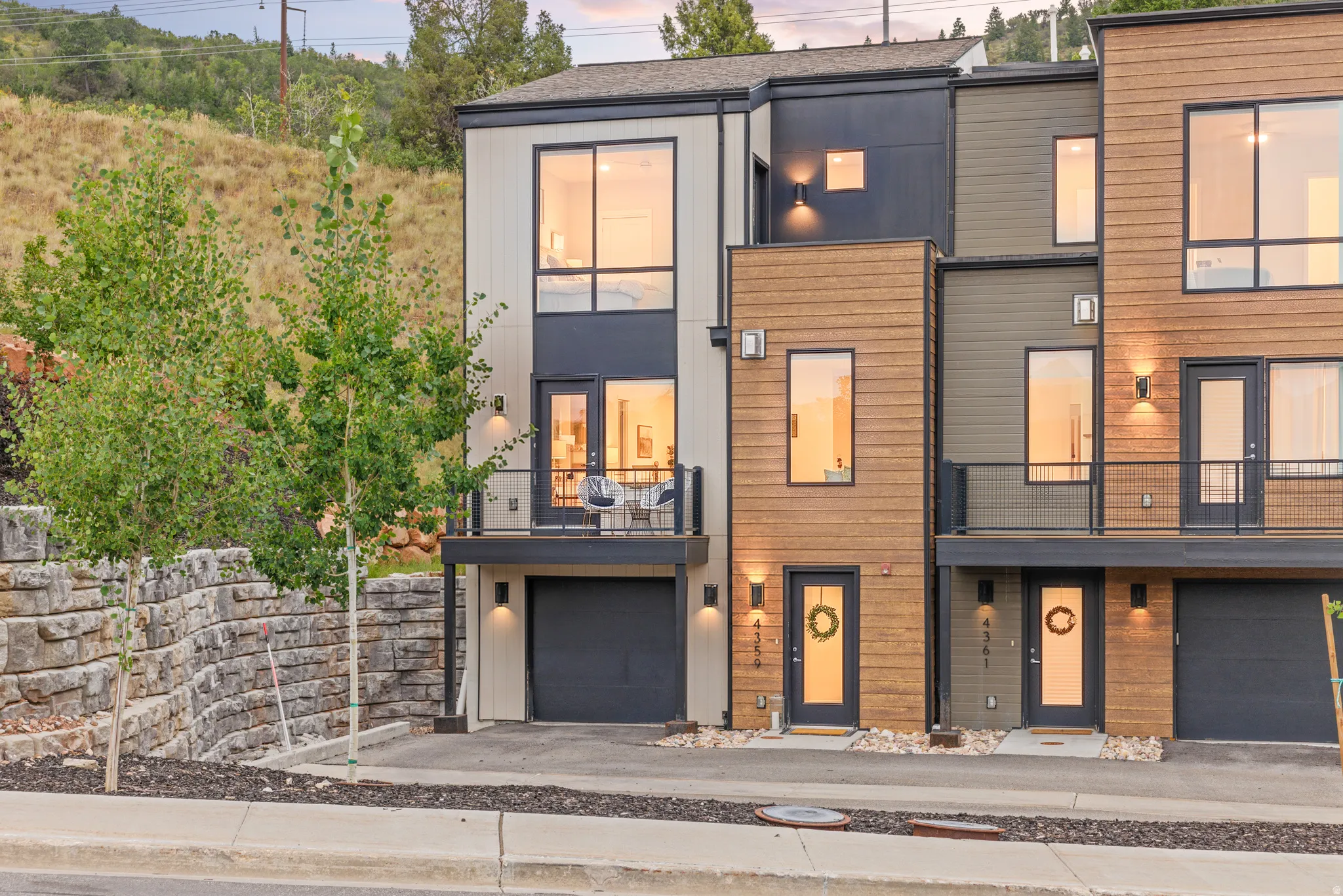 Modern facade featuring horizontal wood-tone siding and dark accent panels