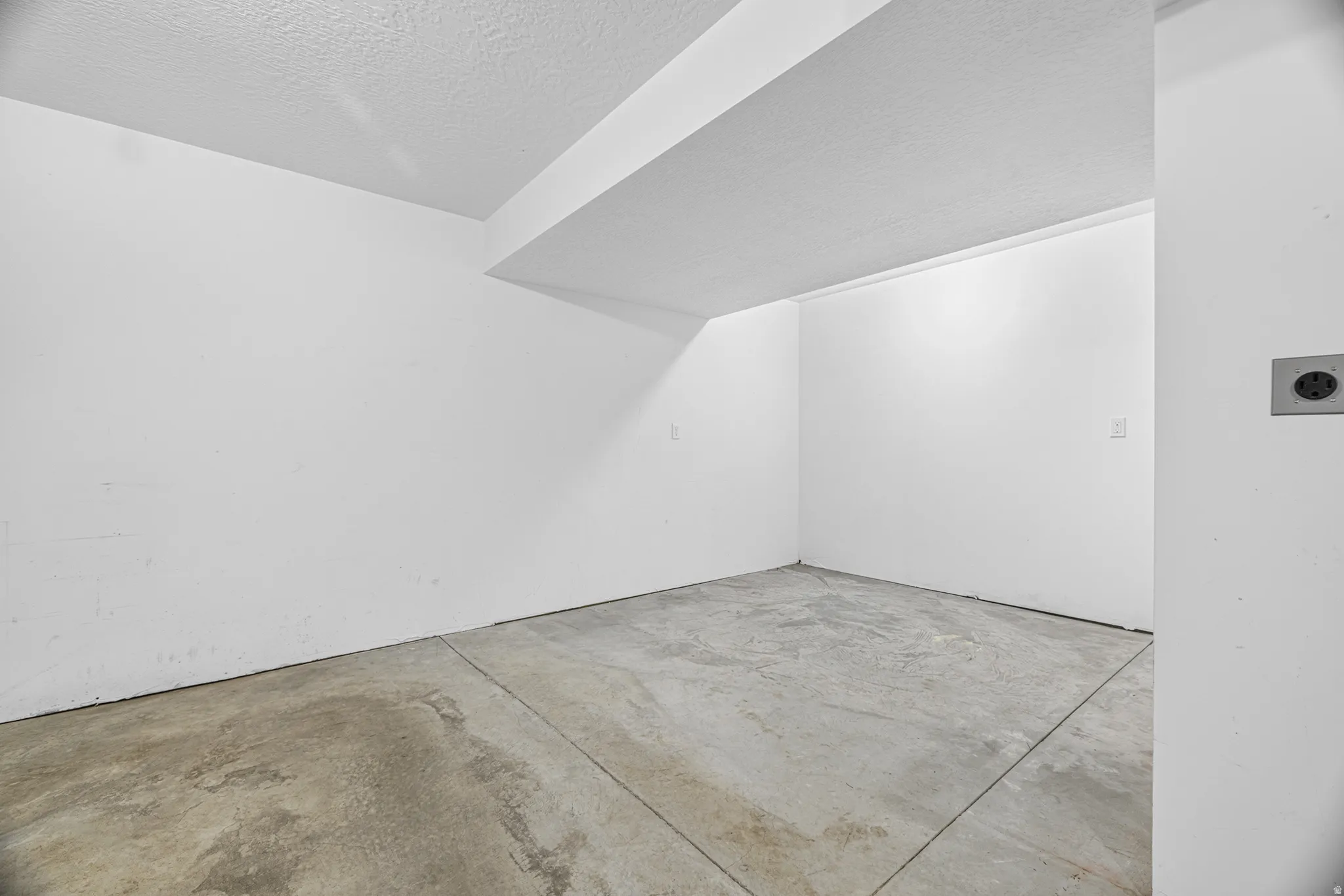 Concrete flooring with white painted walls