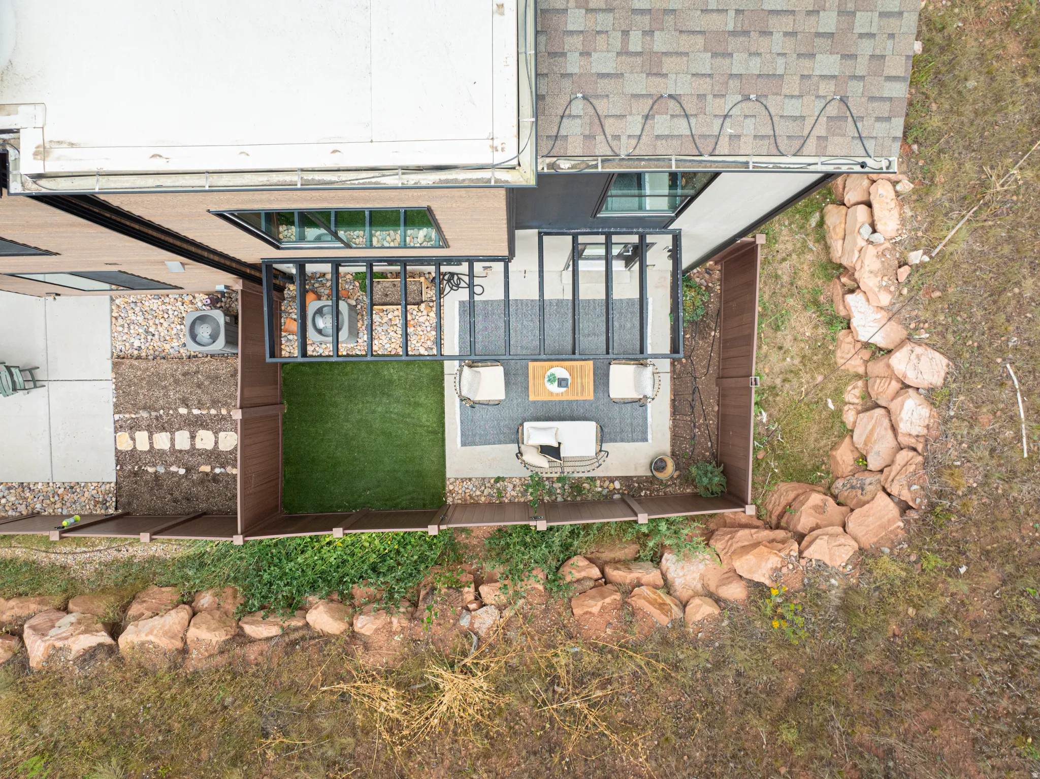 Outdoor patio area featuring a concrete surface, a slatted pergola, and an artificial turf section