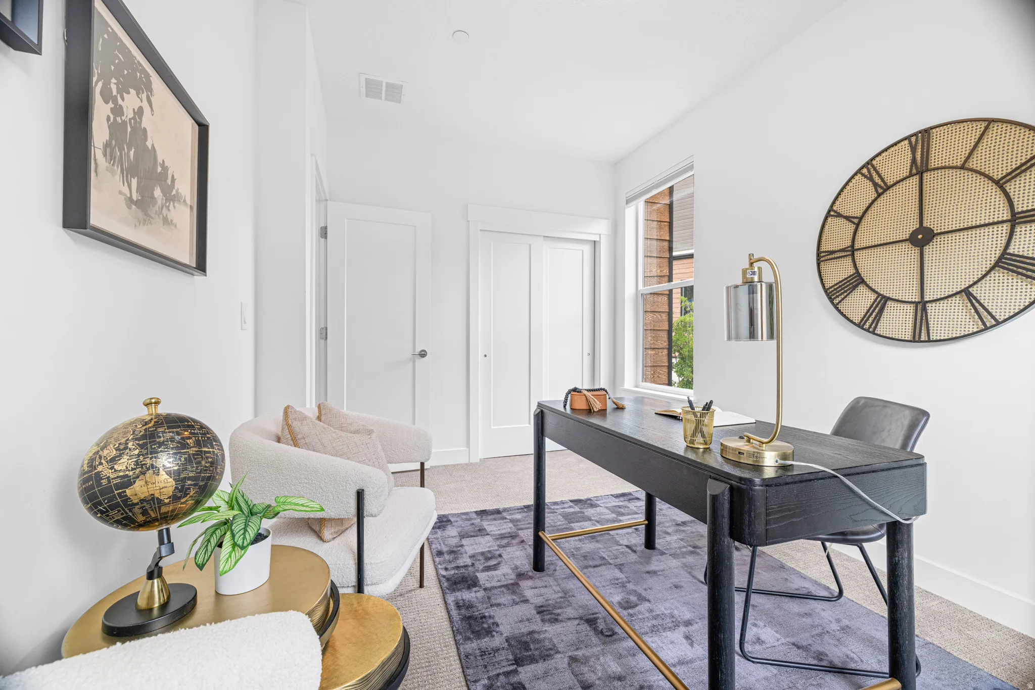 Bright room featuring white walls, a single window, and a built-in closet with sliding doors