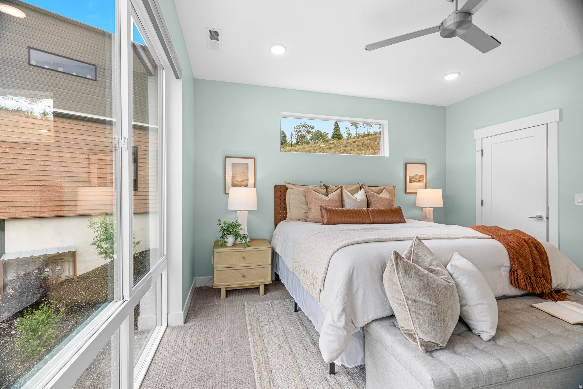 Expansive multi-pane windows, recessed ceiling lighting, contemporary ceiling fan, horizontal accent window, and a white interior door