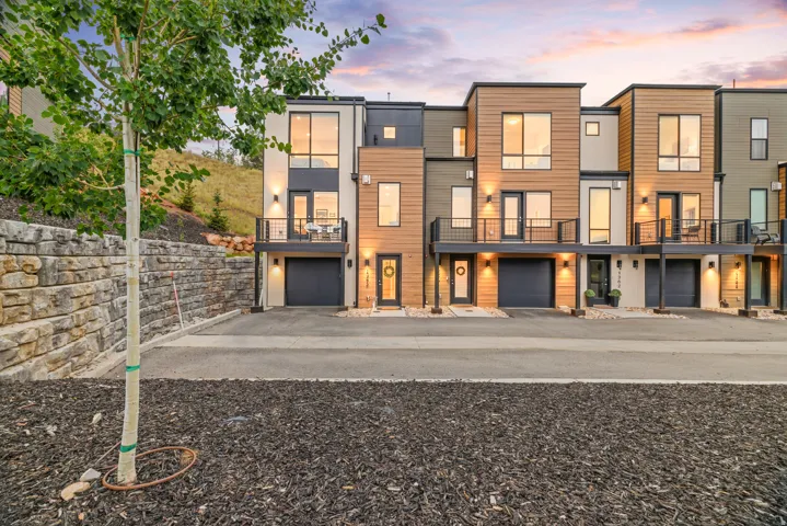 Contemporary townhomes featuring multi-level facades, integrated garages, and private balconies