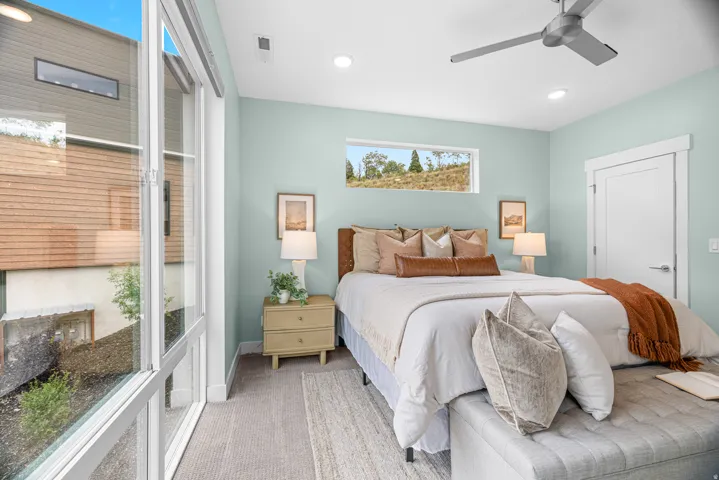 Expansive multi-pane windows, recessed ceiling lighting, contemporary ceiling fan, horizontal accent window, and a white interior door