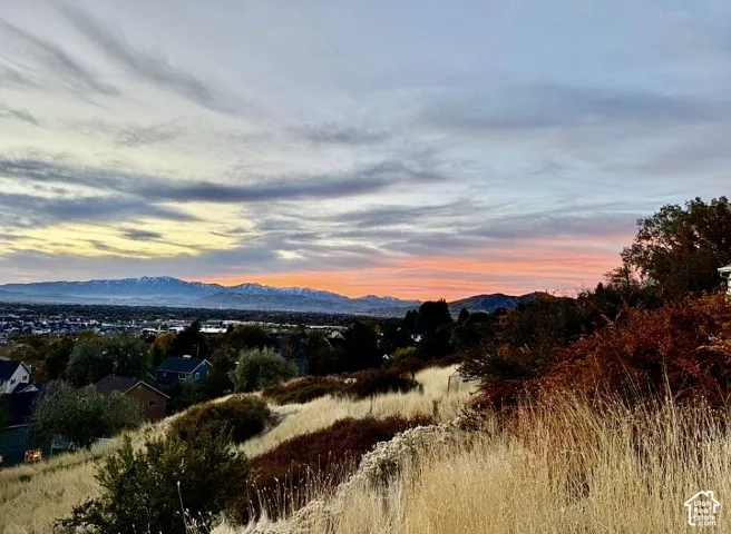 Expansive scenery featuring distant mountains and a vibrant sky