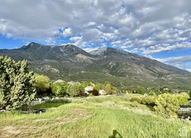 Mountain backdrop, verdant hillsides, established neighborhood setting