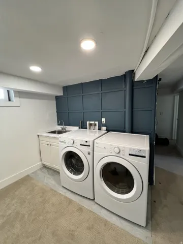 Built-in cabinetry with integrated sink, recessed lighting, and accent wall paneling