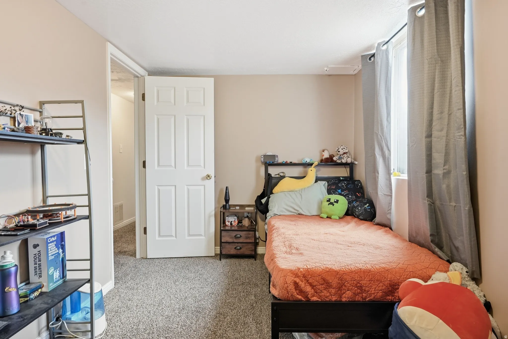 Neutral-toned walls complement the carpeted flooring