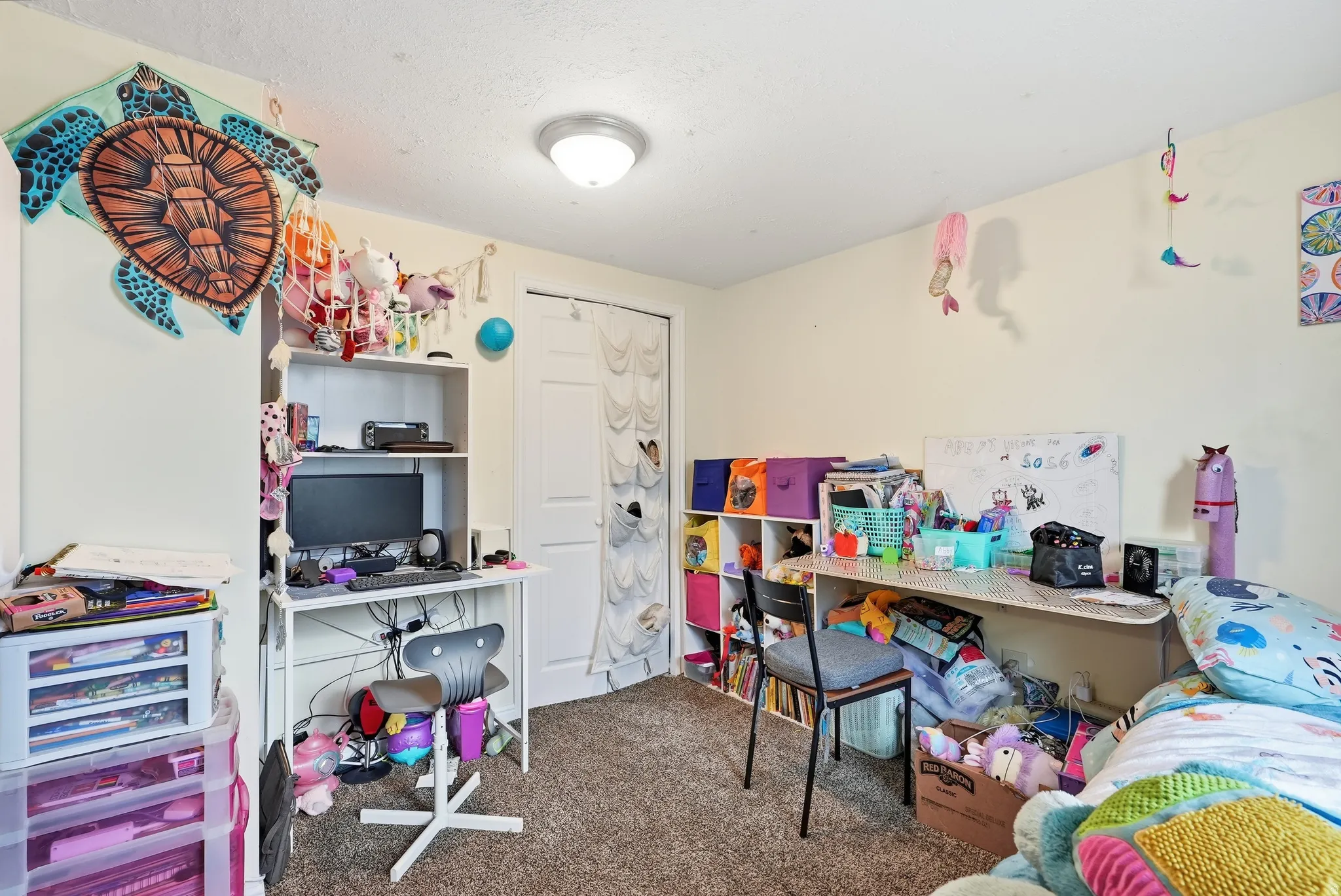 Carpeted flooring, white walls, flush-mount ceiling light, and a white interior door