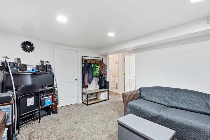 Carpeted flooring, recessed lighting, white painted walls, and white paneled doors