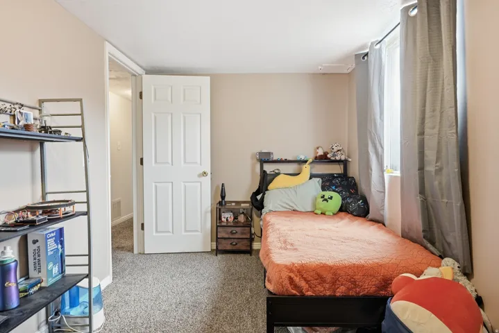 Neutral-toned walls complement the carpeted flooring