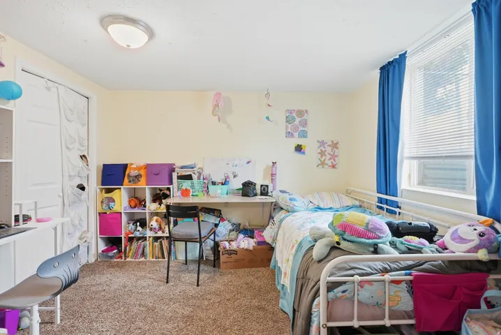 Neutral-toned walls complement the carpeted flooring