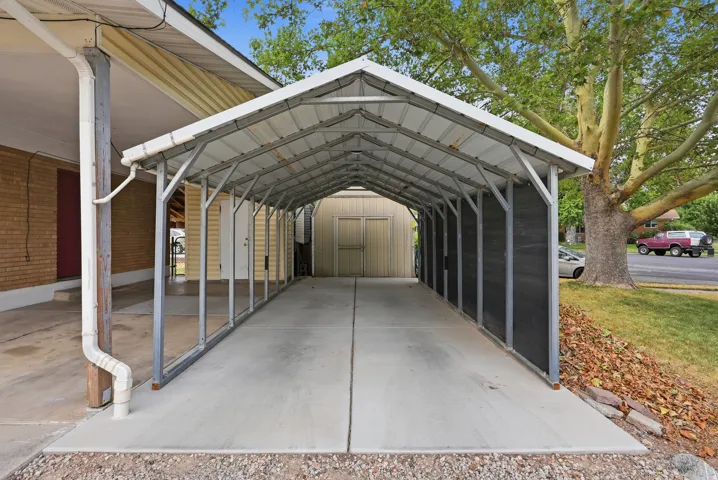Covered carport with a metal roof and concrete pad