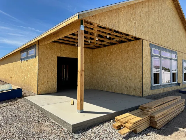 Covered concrete patio with exposed wood framing