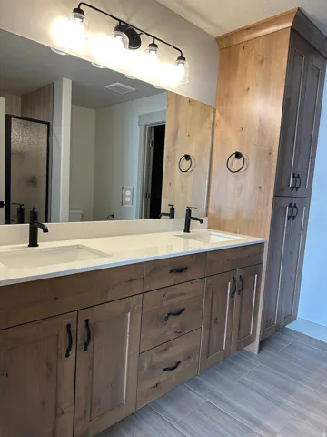 Dual vanities with white countertops and undermount sinks