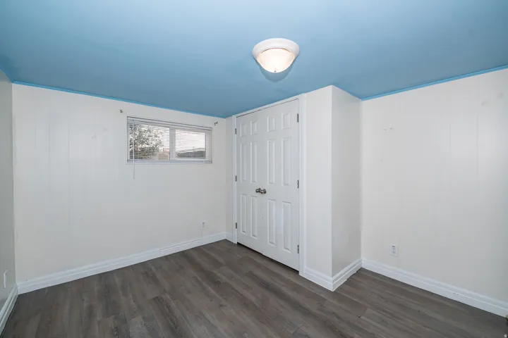 Wood-finish flooring with white baseboards