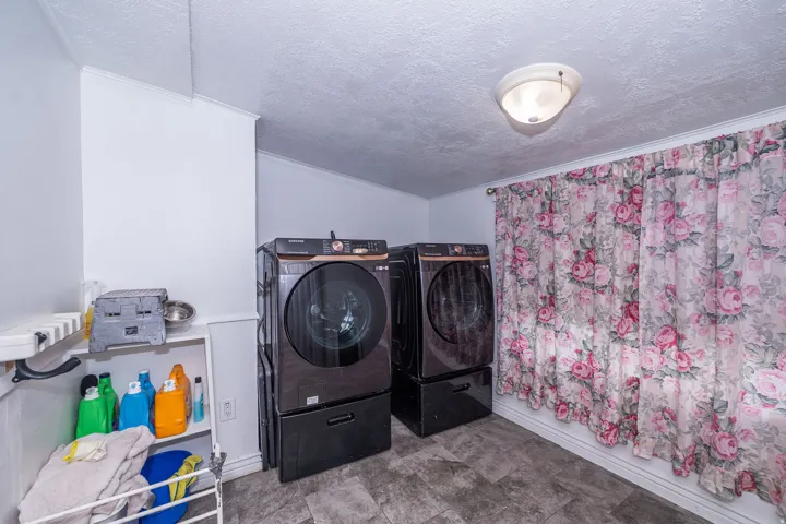 Laundry area featuring tile-style flooring and a flush-mount ceiling light