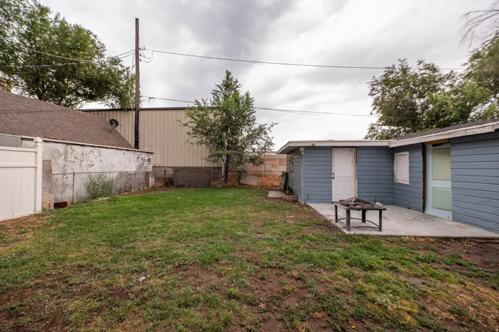 Expansive backyard with a concrete patio