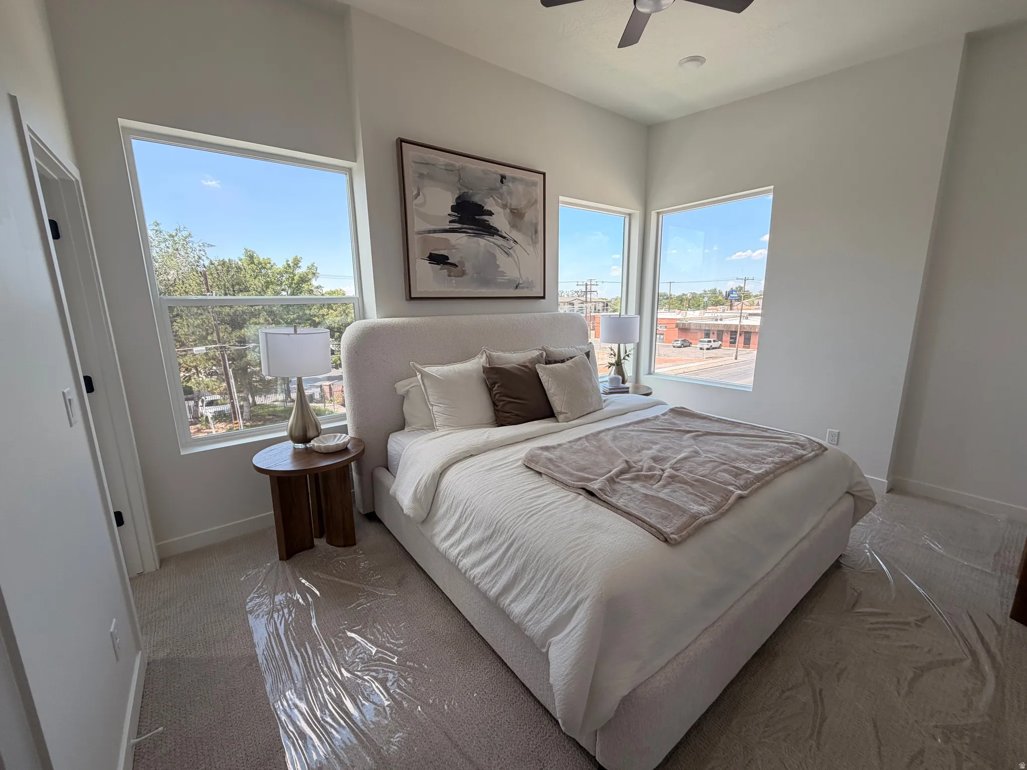 Vaulted ceilings, recessed lighting, ceiling fan, multiple windows, and light-toned carpet flooring