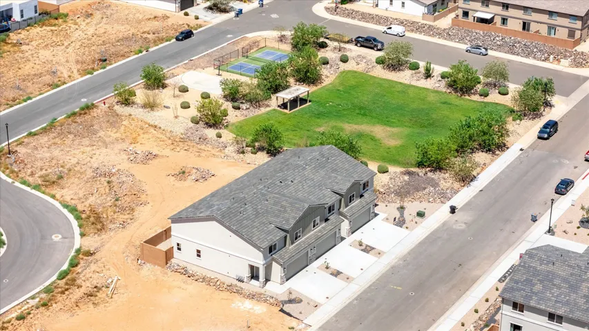 Newly constructed residential property featuring a multi-car garage, paved driveway, and established streets