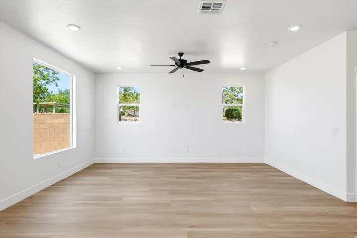 Recessed lighting, wood-finish flooring, ceiling fan, multiple windows