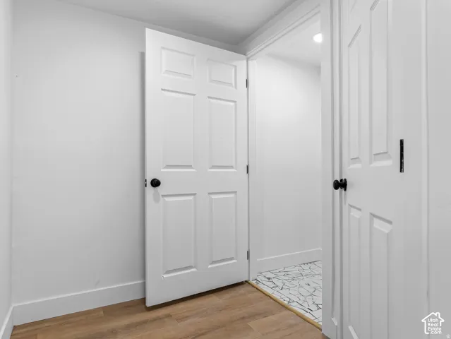 Wood-finish flooring with white baseboards