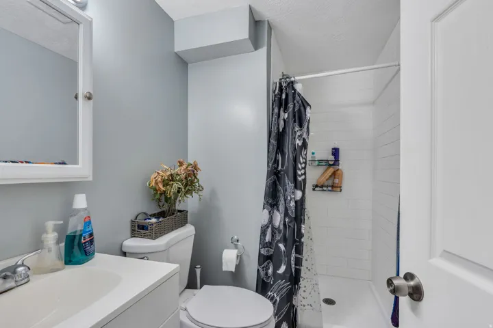Bathroom with a white vanity, integrated sink, and wall-mounted medicine cabinet