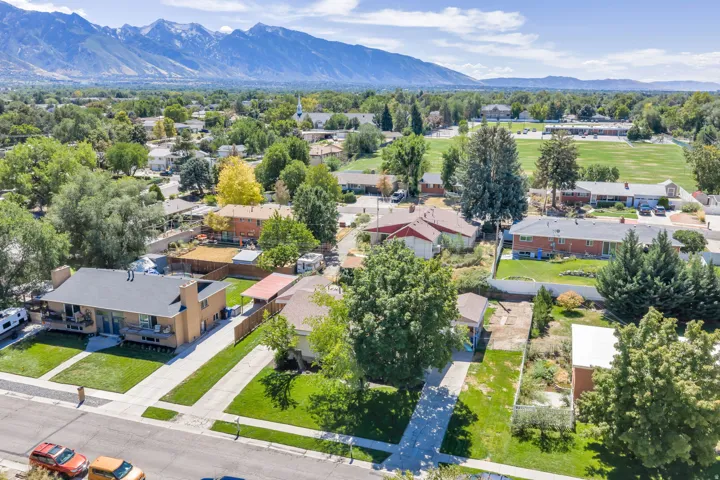 Aerial perspective of residential properties with lush green lawns and mature trees