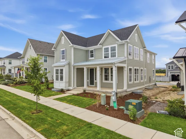 Two-story residence featuring light green siding and white trim