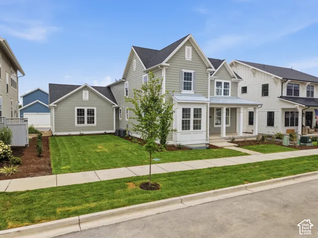 Modern farmhouse architecture featuring light green horizontal siding and white trim