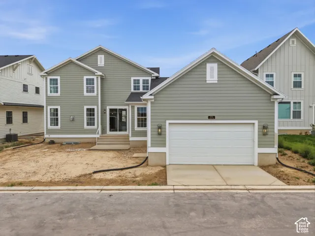 Two-story residence featuring light green horizontal siding and white trim