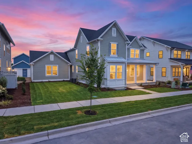 Two-story residence featuring light gray siding with white trim