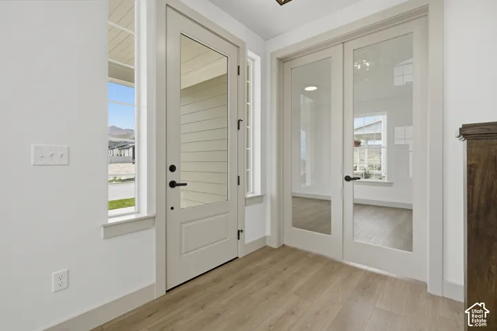 Wood-finish flooring with white baseboards