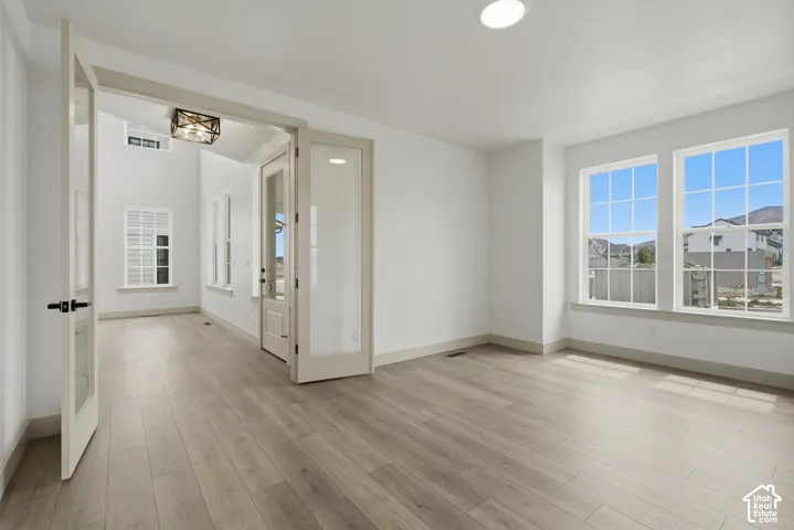 Wood-finish flooring, recessed lighting, and expansive windows