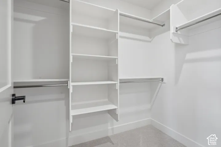 Primary Suite, closet 1. Integrated shelving system with multiple storage levels and chrome hanging rods