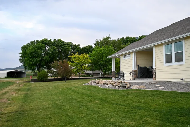 Expansive grassy yard with mature trees