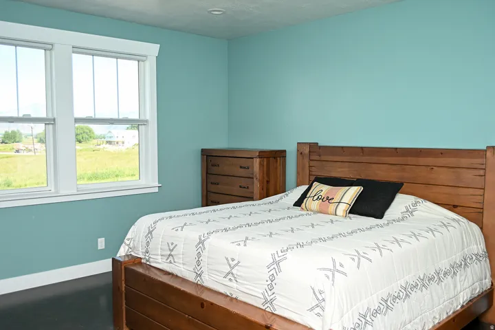 Dual windows with white trim, wood-finish flooring, and recessed lighting
