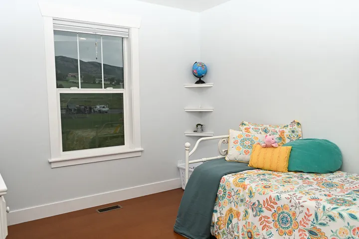 White trim accents a single window with a mountain backdrop