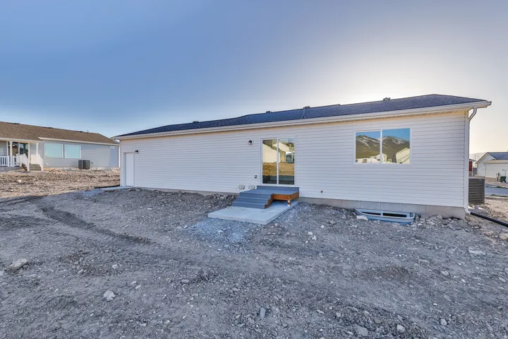 White siding exterior with a dark shingle roof