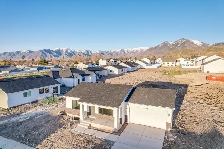 Newly constructed residence with a two-car garage and a paved driveway