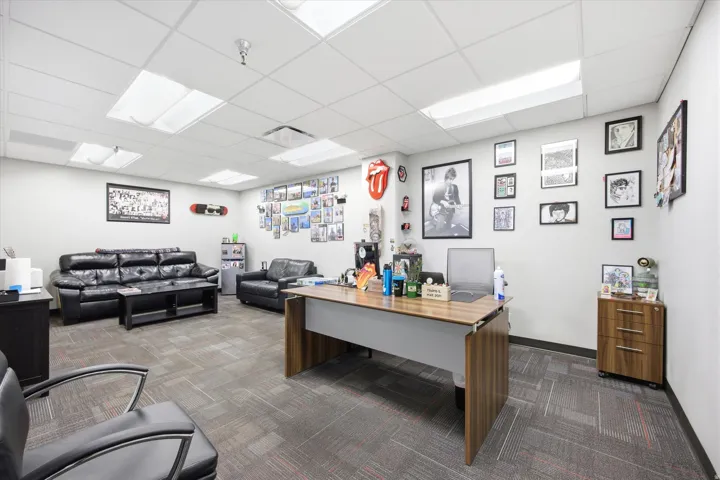 Recessed lighting, drop ceiling, and carpeted flooring