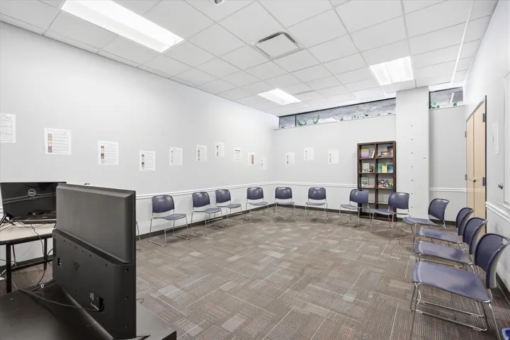 Recessed lighting, drop ceiling, wall-to-wall carpeting, built-in shelving, and transom windows