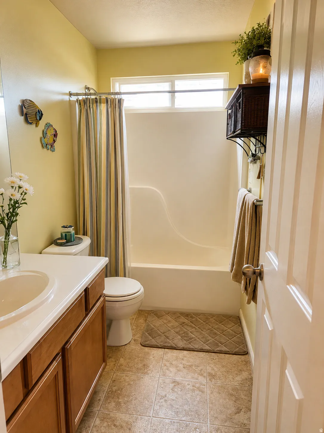 Guest Bathroom featuring a vanity with wood-finish cabinetry, a white countertop, and an integrated sink