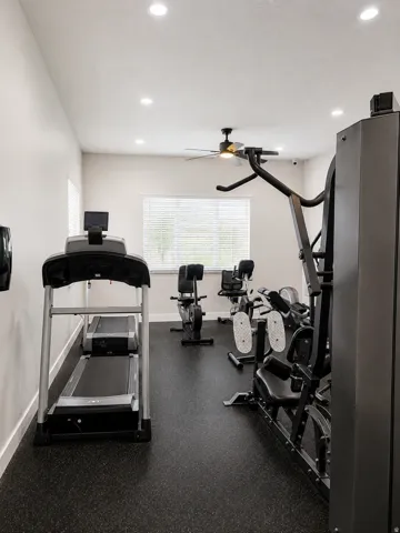 Dedicated fitness area featuring recessed lighting, a ceiling fan, and durable rubber flooring