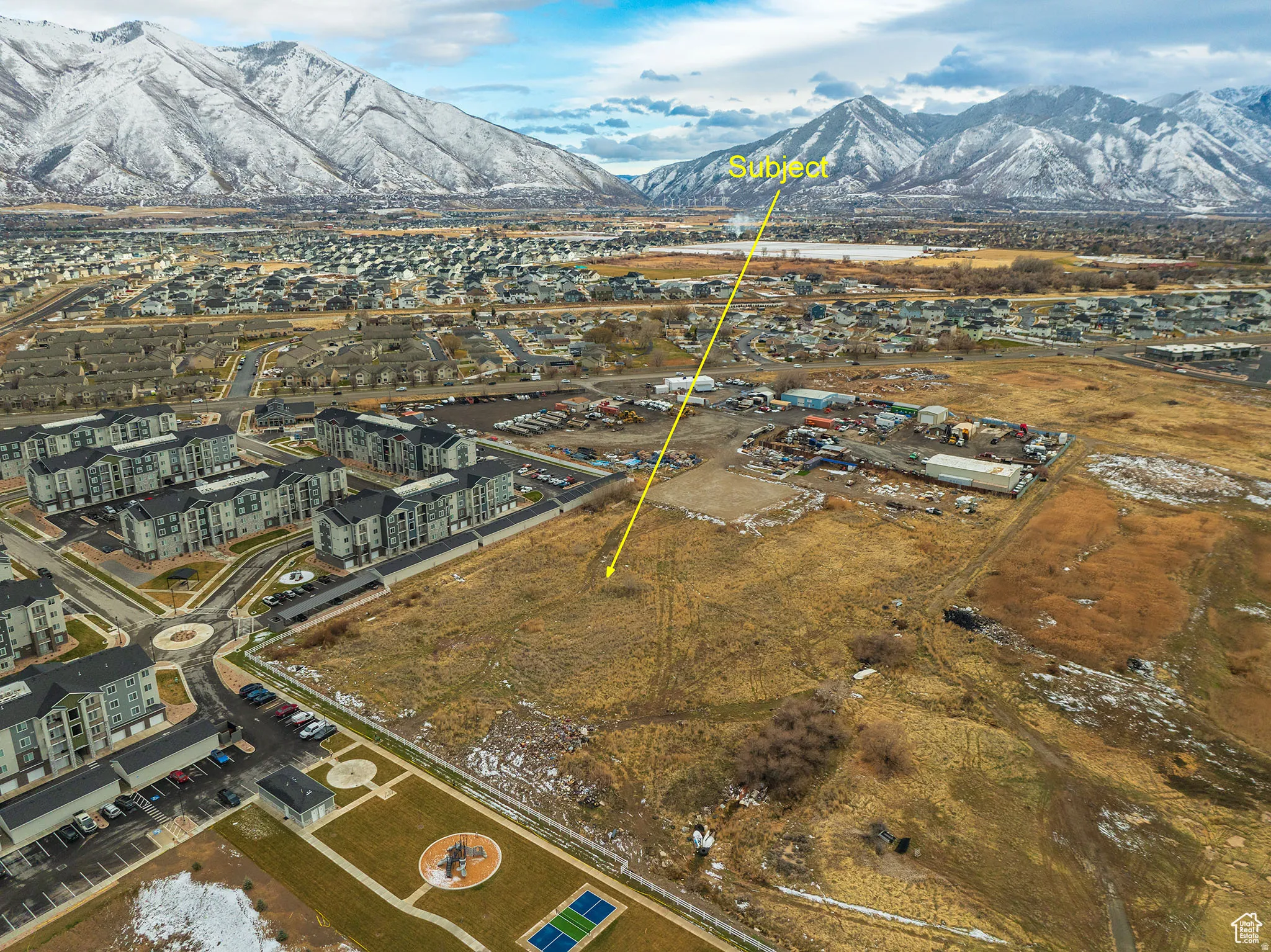 Expansive lot featuring a natural, undeveloped landscape with distant snow-capped mountains