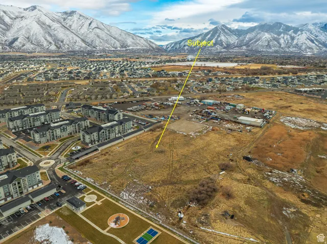 Expansive lot featuring a natural, undeveloped landscape with distant snow-capped mountains